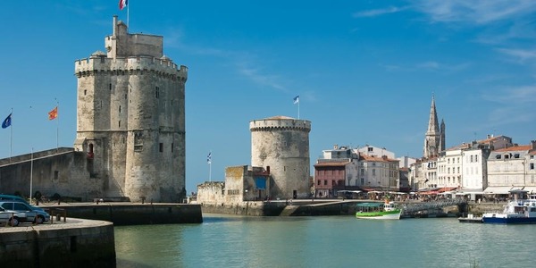 On y entre par la mer en passant entre la tour Saint-Nicolas et la tour de la Chaîne. C'est le port de...