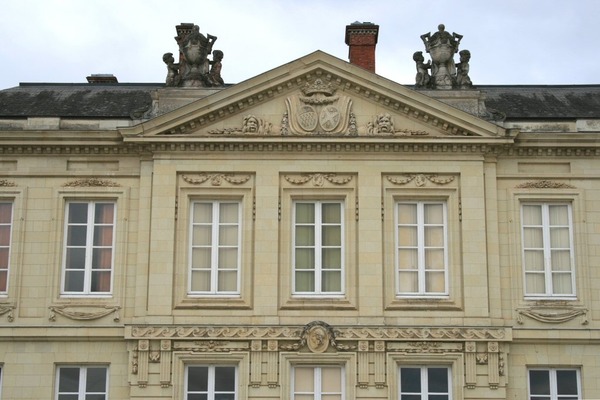 Que représentent les putti situés aux angles de la toiture du château de Craon ?